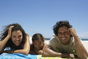 Couple with their daughter on the beach